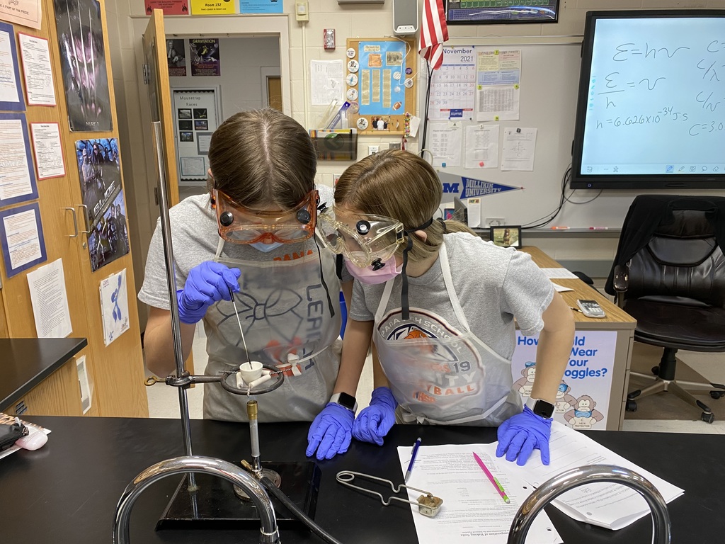 Advanced chemistry students working on an analysis of sodium bicarbonate.