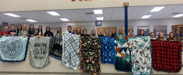 Good Deeds group members pose with their blankets they made.